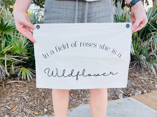 In a Field of Roses, She is a Wildflower Canvas Flag